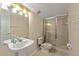 Bathroom featuring a pedestal sink, toilet, and shower with glass doors and tile surround at 4022 Valrico Grove Dr, Valrico, FL 33594