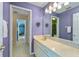 Bathroom with double sinks and a large mirror with vanity and decorative lighting at 4022 Valrico Grove Dr, Valrico, FL 33594