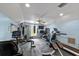 Spacious home gym with fitness equipment, rubber flooring, and ample natural light for a complete workout experience at 4022 Valrico Grove Dr, Valrico, FL 33594