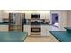Modern kitchen with stainless steel appliances and a view into the adjacent bedroom at 4022 Valrico Grove Dr, Valrico, FL 33594