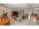 Bright living room featuring a fireplace, tile flooring, and views of the front entrance at 4022 Valrico Grove Dr, Valrico, FL 33594