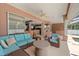 Covered patio features comfortable seating, ceiling fan, and sliding glass doors leading to the home's interior at 4022 Valrico Grove Dr, Valrico, FL 33594