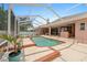 Screened-in pool with spa, spacious deck, and covered outdoor kitchen, perfect for outdoor relaxation at 4022 Valrico Grove Dr, Valrico, FL 33594