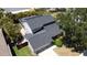 An aerial view of the home showcasing the roof, screened-in porch, landscaping, and surrounding neighborhood at 4915 Pennsbury Dr, Tampa, FL 33624