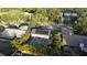 Aerial view of backyard featuring screened-in pool, solar panels, and landscaped yard at 4915 Pennsbury Dr, Tampa, FL 33624