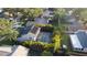 Aerial view of backyard with pool, mature landscaping, and adjacent homes at 4915 Pennsbury Dr, Tampa, FL 33624