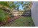 Landscaped backyard with lush greenery, a wooden fence, and potential for gardening or relaxation at 4915 Pennsbury Dr, Tampa, FL 33624