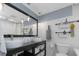 Bathroom featuring a dual sink vanity with storage, subway tile walls, and pendant lighting at 4915 Pennsbury Dr, Tampa, FL 33624