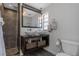 Modern bathroom featuring a double sink vanity, a large mirror, subway tile backsplash, and a glass-enclosed shower at 4915 Pennsbury Dr, Tampa, FL 33624