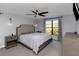 Comfortable bedroom with a queen bed, ceiling fan, bedside tables, and a window that offers natural light and view at 4915 Pennsbury Dr, Tampa, FL 33624