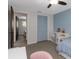 Bedroom featuring a blue accent wall, closet with louvered doors, and white shelving at 4915 Pennsbury Dr, Tampa, FL 33624