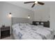 Well-lit bedroom boasts a comfortable bed with Eiffel Tower themed bedding, ceiling fan, and modern decor at 4915 Pennsbury Dr, Tampa, FL 33624