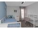 Bedroom features a ceiling fan, blue accent wall, white bed and a desk with a chair at 4915 Pennsbury Dr, Tampa, FL 33624