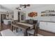 Bright dining room featuring wood-look tile floor, decorative ceiling fans, and a built-in bar area at 4915 Pennsbury Dr, Tampa, FL 33624