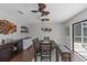 Bright dining room featuring wood-look tile floor, decorative ceiling fans, and a built-in bar area at 4915 Pennsbury Dr, Tampa, FL 33624