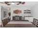 Bright dining room featuring wood-look tile floor, decorative ceiling fans, and a built-in bar area at 4915 Pennsbury Dr, Tampa, FL 33624