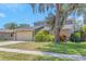 Charming home featuring a well-manicured lawn, mature trees, and a convenient two-car garage at 4915 Pennsbury Dr, Tampa, FL 33624