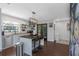 Modern kitchen featuring stainless steel appliances, island with seating and tiled backsplash at 4915 Pennsbury Dr, Tampa, FL 33624