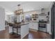 Well-lit kitchen with stainless steel appliances, island with seating and a view to the backyard at 4915 Pennsbury Dr, Tampa, FL 33624