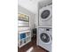 Functional laundry area with stacked washer/dryer, storage shelving, and a practical design at 4915 Pennsbury Dr, Tampa, FL 33624