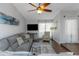 Spacious living room with natural light, comfortable gray sectional sofa, ceiling fan, and stylish decor at 4915 Pennsbury Dr, Tampa, FL 33624