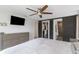 A well-furnished bedroom featuring a king bed, with doors leading to a walk-in closet and the attached bathroom at 4915 Pennsbury Dr, Tampa, FL 33624
