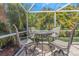 Screened patio area showcasing a table and chairs, perfect for enjoying the outdoors at 4915 Pennsbury Dr, Tampa, FL 33624