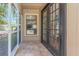 Covered patio entrance with tiled floor, window, and double doors offering convenient access at 4915 Pennsbury Dr, Tampa, FL 33624