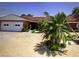 Charming single-story home with a red tile roof, brick facade, and a well-maintained gravel yard with tropical landscaping at 510 64Th Ave, St Pete Beach, FL 33706