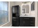 Modern bathroom featuring black vanity with white countertop and sleek, illuminated mirror at 5193 Higate Rd, Spring Hill, FL 34609