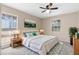 Staged bedroom with a large bed and two windows providing natural lighting at 5193 Higate Rd, Spring Hill, FL 34609