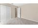 Bedroom features carpet, closet with white bi-fold doors, and neutral colored walls at 5193 Higate Rd, Spring Hill, FL 34609