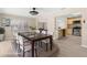 Staged dining room featuring a dark wood table and a view into the living room and kitchen at 5193 Higate Rd, Spring Hill, FL 34609