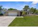 Charming single-story home with a two-car garage and well-manicured lawn at 5193 Higate Rd, Spring Hill, FL 34609