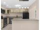 Well-appointed kitchen featuring stainless steel appliances, granite countertops, and a breakfast bar at 5193 Higate Rd, Spring Hill, FL 34609