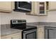 Close-up of a kitchen with granite countertops, and stainless steel appliances at 5193 Higate Rd, Spring Hill, FL 34609