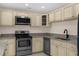 Stylish kitchen with stainless steel appliances, granite countertops, and ample storage at 5193 Higate Rd, Spring Hill, FL 34609