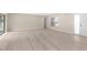 Spacious living room with new hardwood floors and sliding door for outside access at 5193 Higate Rd, Spring Hill, FL 34609