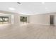 Spacious open floor plan with light wood-look floors and large windows at 5193 Higate Rd, Spring Hill, FL 34609