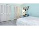 Bedroom with cool blue walls, tile flooring, closet storage, and bright lighting at 5267 81St N St # 8, St Petersburg, FL 33704