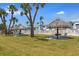 Community pool area featuring sun shelters, seating, and lush landscaping at 5267 81St N St # 8, St Petersburg, FL 33704