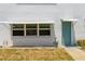 Charming exterior with awning-covered windows, a colorful door, and a well-maintained yard at 5267 81St N St # 8, St Petersburg, FL 33704