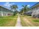 Beautiful exterior showcasing lush landscaping, building facade, and communal walkway at 5267 81St N St # 8, St Petersburg, FL 33704