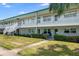 Exterior view of a two-story building with well-kept lawns and outdoor seating at 5267 81St N St # 8, St Petersburg, FL 33704