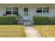 Charming condo front entrance with well maintained landscaping and a gray stone pathway and windows at 5267 81St N St # 8, St Petersburg, FL 33704