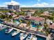 Aerial view of waterfront property highlighting the dual pools, lush landscaping, and marina at 5823 Bowen Daniel Dr # 906, Tampa, FL 33616