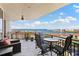 Enjoy stunning water views from this private balcony with seating and table, perfect for relaxation and outdoor dining at 5823 Bowen Daniel Dr # 906, Tampa, FL 33616