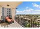 Private balcony with a lounge chair that overlooks a park, pool and city at 5823 Bowen Daniel Dr # 906, Tampa, FL 33616
