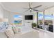 Bright bedroom with a beautiful water view, ceiling fan, television and access to a private balcony at 5823 Bowen Daniel Dr # 906, Tampa, FL 33616