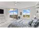 Bedroom featuring a private balcony, bright windows and a ceiling fan at 5823 Bowen Daniel Dr # 906, Tampa, FL 33616